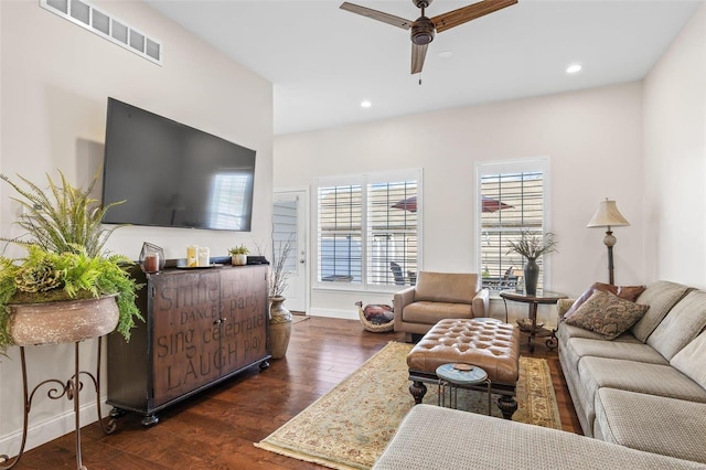 living area featuring visible vents, baseboards, recessed lighting, a ceiling fan, and dark wood-style flooring