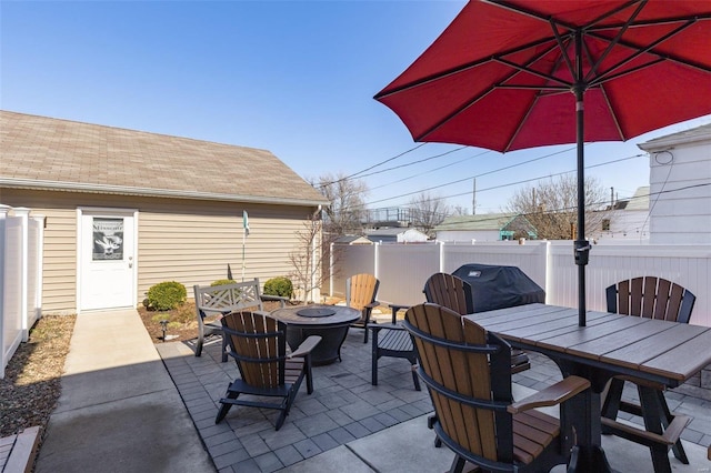 view of patio / terrace featuring a fire pit, area for grilling, outdoor dining space, and fence