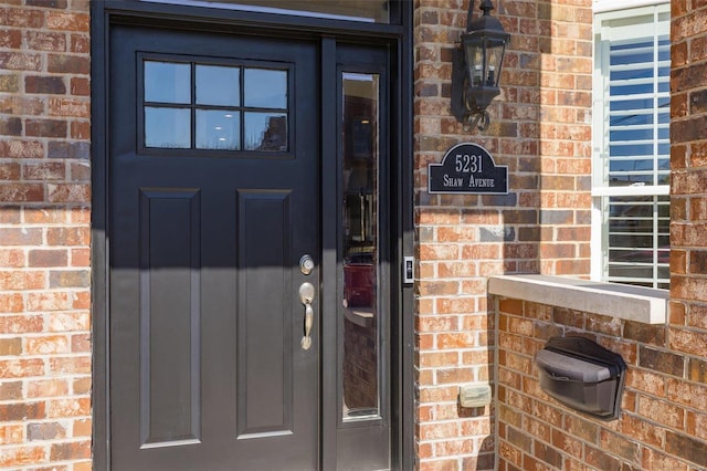 entrance to property with brick siding