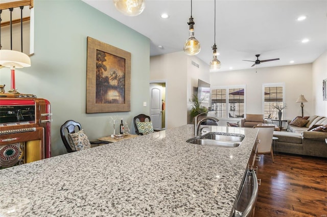 kitchen with visible vents, dark wood finished floors, recessed lighting, a sink, and open floor plan