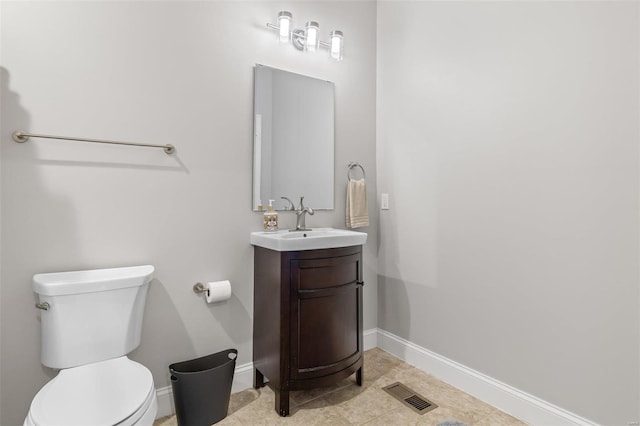 bathroom with visible vents, baseboards, toilet, and vanity