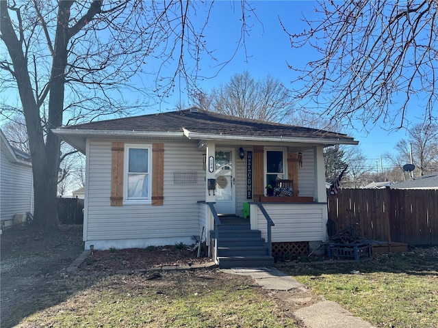 bungalow with a porch and fence