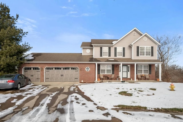 view of front facade featuring brick siding, driveway, and a garage