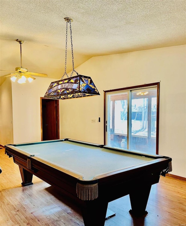 recreation room featuring light wood finished floors, ceiling fan, vaulted ceiling, a textured ceiling, and billiards