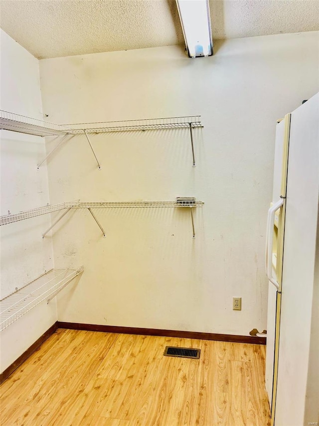 walk in closet featuring visible vents and light wood-style flooring