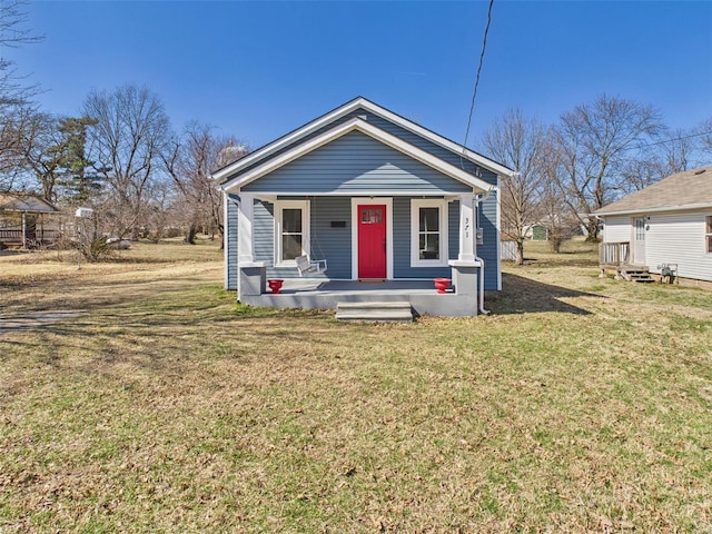 view of front of property featuring covered porch and a front yard