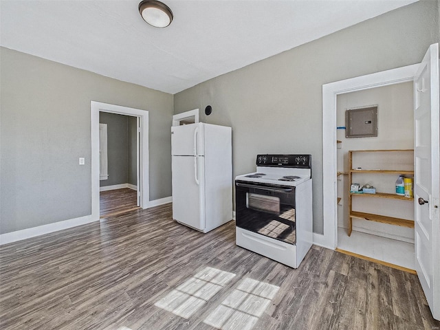 kitchen with electric panel, wood finished floors, electric range oven, freestanding refrigerator, and baseboards