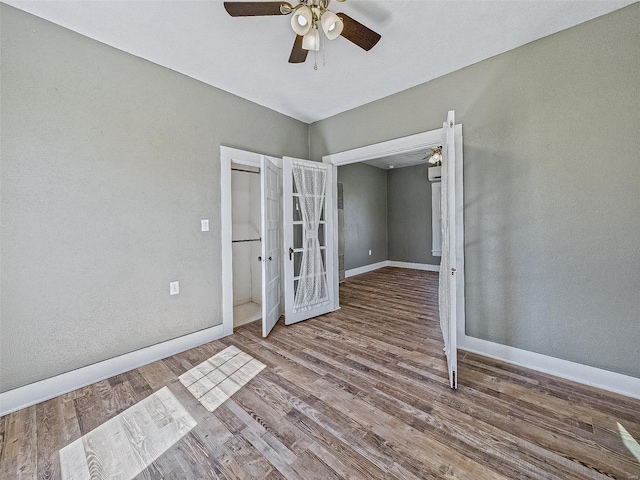 unfurnished room featuring ceiling fan, french doors, baseboards, and wood finished floors