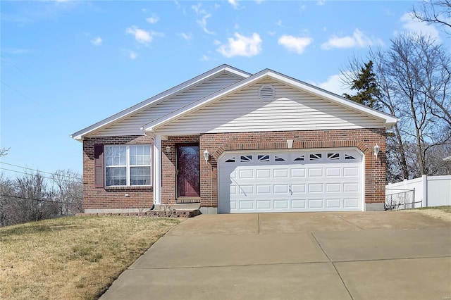 ranch-style home featuring fence, concrete driveway, a front yard, an attached garage, and brick siding