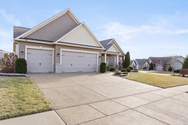 view of front of home with a garage, driveway, board and batten siding, and a front lawn