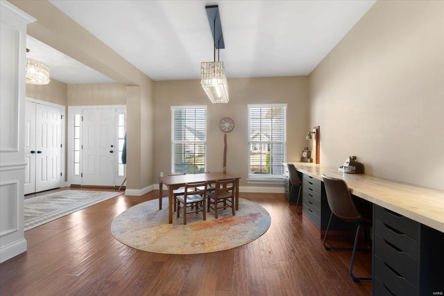 dining room featuring baseboards and dark wood-style flooring