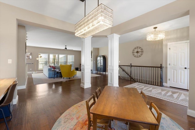 dining area with decorative columns, a ceiling fan, baseboards, and wood-type flooring