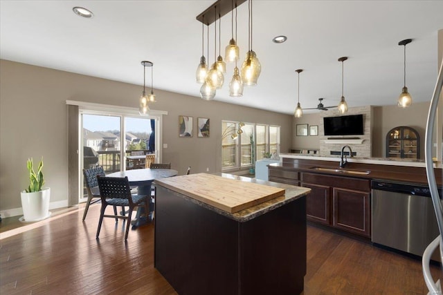 kitchen featuring a kitchen island, dark wood finished floors, open floor plan, dishwasher, and a sink