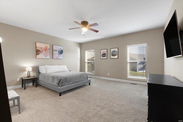 bedroom featuring light carpet, visible vents, ceiling fan, and baseboards