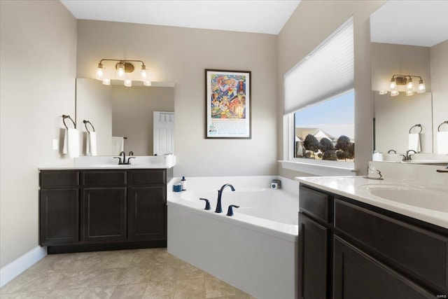 full bath featuring a sink, two vanities, a bath, and tile patterned floors