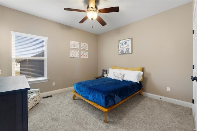 carpeted bedroom featuring visible vents, ceiling fan, and baseboards