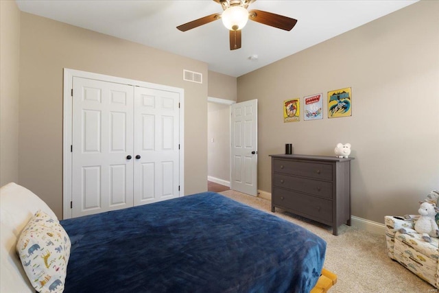 carpeted bedroom with a ceiling fan, baseboards, visible vents, and a closet