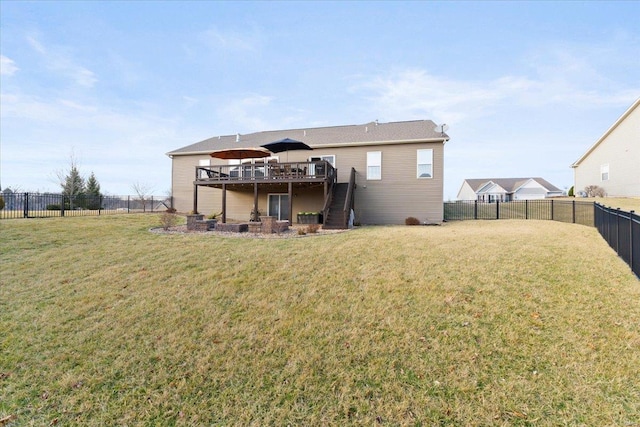 rear view of house featuring a fenced backyard, a wooden deck, stairs, and a yard