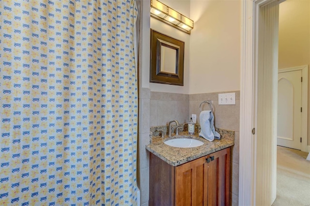 bathroom featuring tile walls and vanity