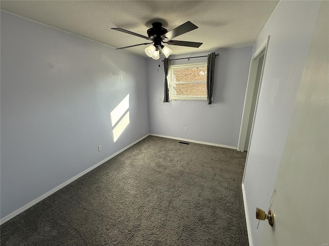 empty room featuring a textured ceiling, a ceiling fan, baseboards, and carpet floors