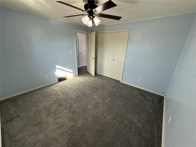 unfurnished bedroom featuring a closet, ceiling fan, a textured ceiling, and carpet