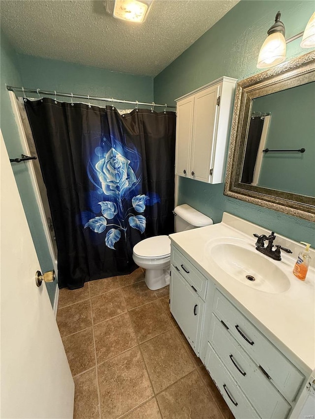 full bath featuring vanity, a textured ceiling, curtained shower, tile patterned floors, and toilet