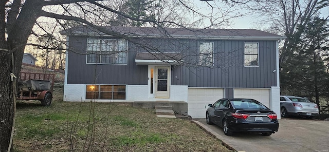 view of front of house featuring brick siding, driveway, and an attached garage