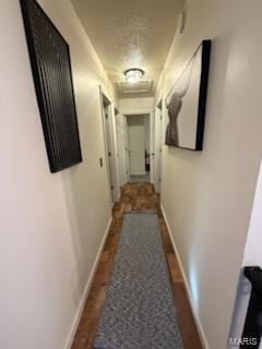 corridor featuring attic access and baseboards