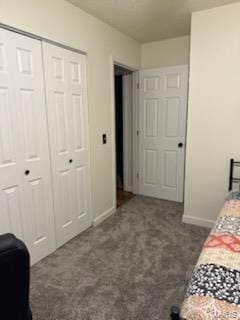 bedroom featuring a closet, baseboards, and carpet flooring