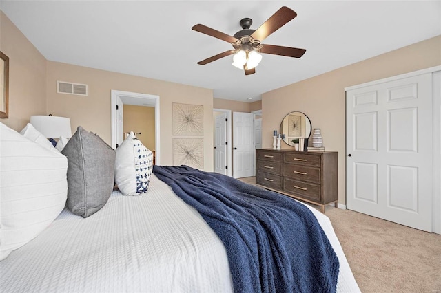 bedroom with visible vents, light carpet, and a ceiling fan