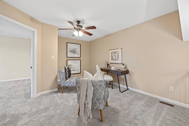 carpeted home office featuring visible vents, baseboards, and a ceiling fan