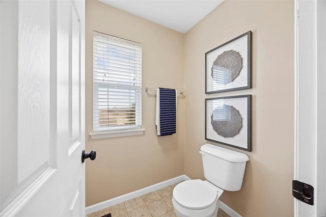 bathroom featuring tile patterned floors, toilet, and baseboards