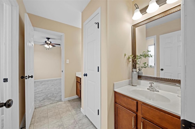 bathroom with tile patterned floors, baseboards, and vanity