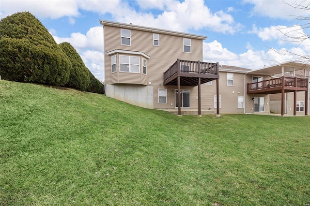 back of house with a lawn and a wooden deck