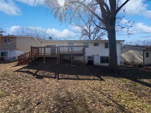 back of house with a deck