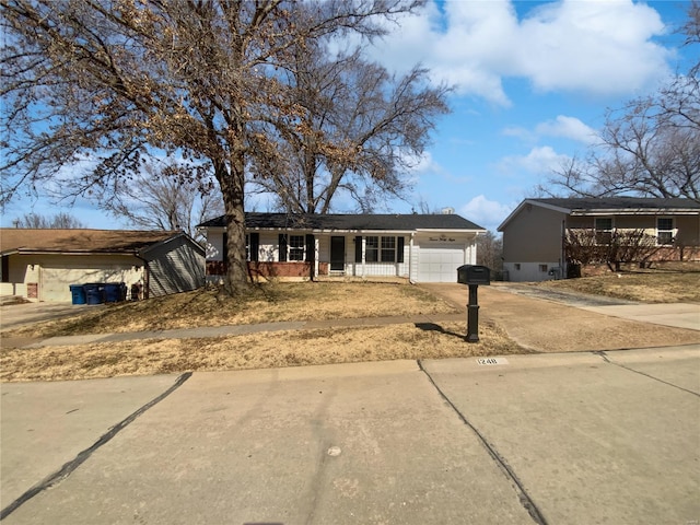 single story home with brick siding, covered porch, concrete driveway, and an attached garage