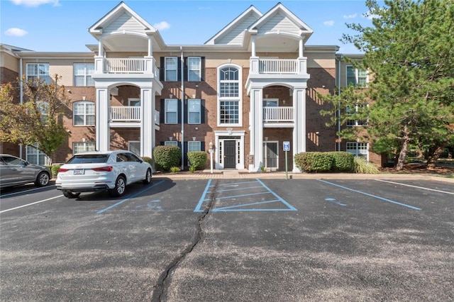 view of property featuring uncovered parking