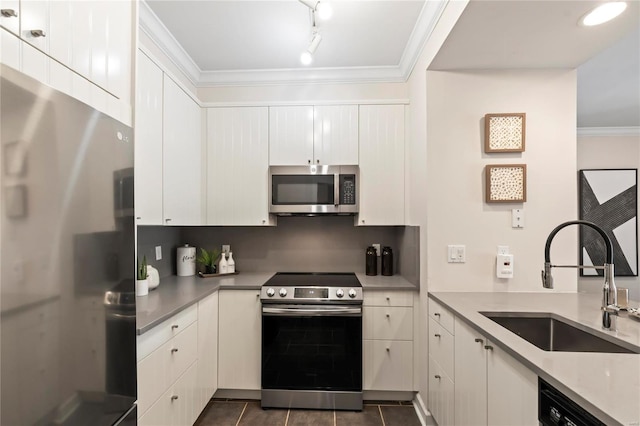 kitchen with white cabinets, stainless steel appliances, crown molding, and a sink