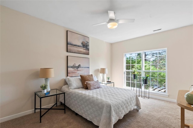 bedroom with visible vents, ceiling fan, baseboards, and carpet