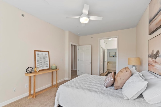 bedroom with ceiling fan, connected bathroom, baseboards, and light carpet