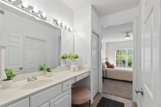 ensuite bathroom with tile patterned flooring, connected bathroom, vanity, and ceiling fan