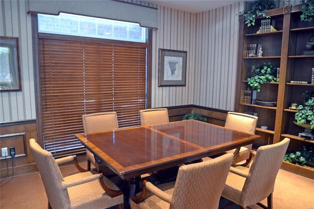 dining space featuring carpet flooring and wallpapered walls