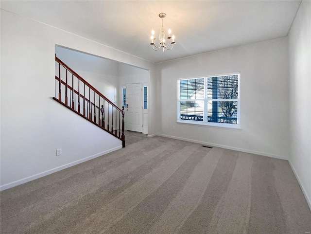 carpeted foyer featuring stairway, a notable chandelier, visible vents, and baseboards