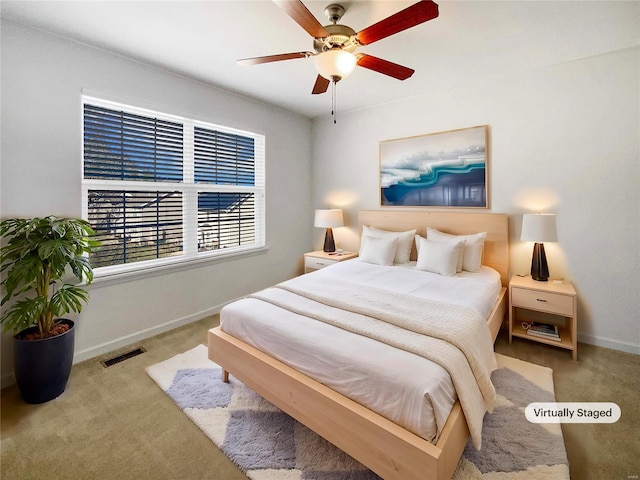 bedroom with a ceiling fan, carpet flooring, baseboards, and visible vents