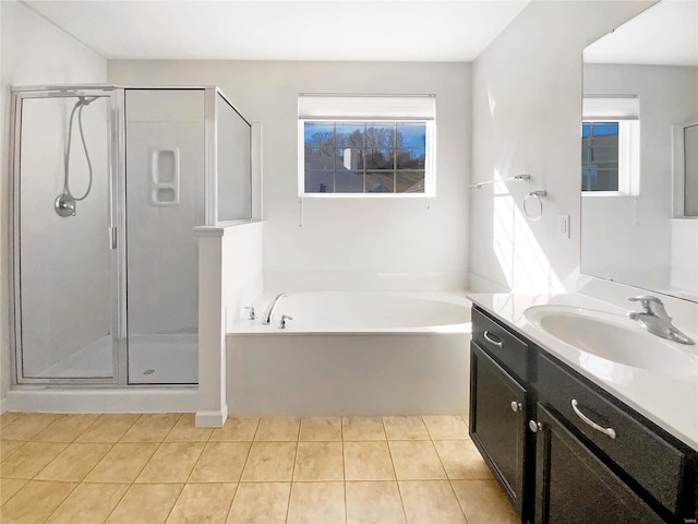 bathroom with a garden tub, a shower stall, and tile patterned flooring