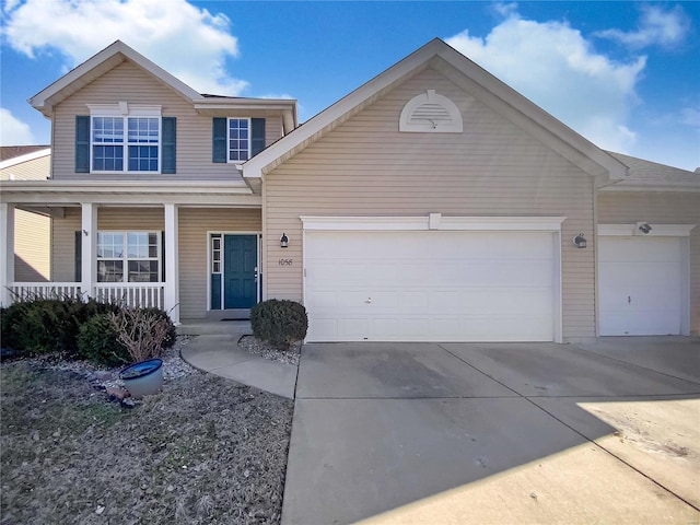 view of front facade with a porch, concrete driveway, and a garage