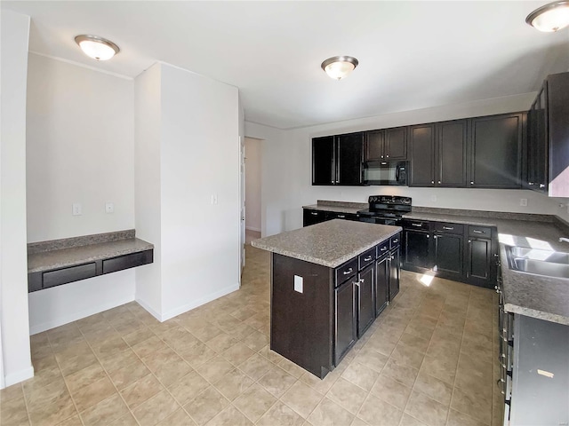 kitchen featuring baseboards, a kitchen island, a sink, black appliances, and light countertops