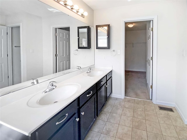 full bathroom with a sink, visible vents, and double vanity