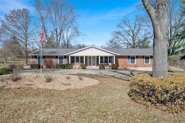 ranch-style home with brick siding and concrete driveway