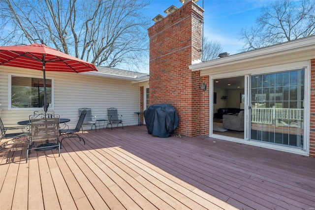 wooden deck featuring outdoor dining area and area for grilling